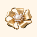 Golden Bow Blossom Brooch — actual supplier photograph on warm ivory