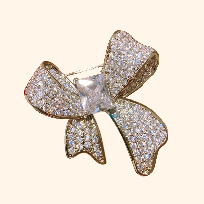Light-luxury High-end Full-diamond Bow Brooch — actual supplier photograph on warm ivory